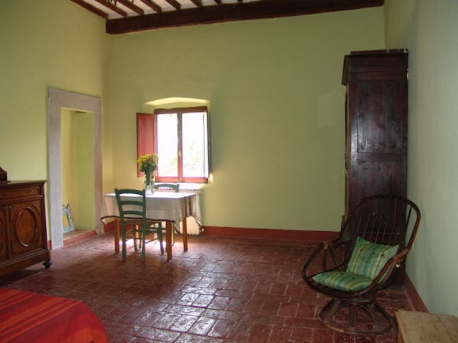 The green colourewd bedroom, furnished in typical Tuscan style