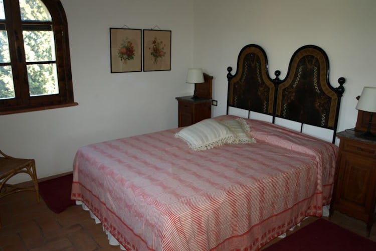 Classical Tuscan decor, wrought iron bedstands and terracotta tiles