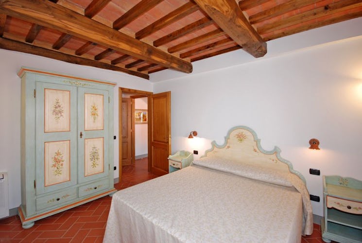 Handpainted furniture and lumiunous bedrooms at Villa Montegufoni