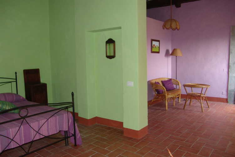 A wide coloured room of the farmhouse