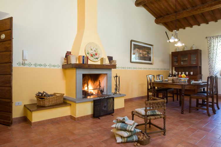 Warm and inviting with a cozy fireplace and wood beam cielings