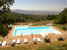 Large family friendly pool with umbrellas and chaise lounges