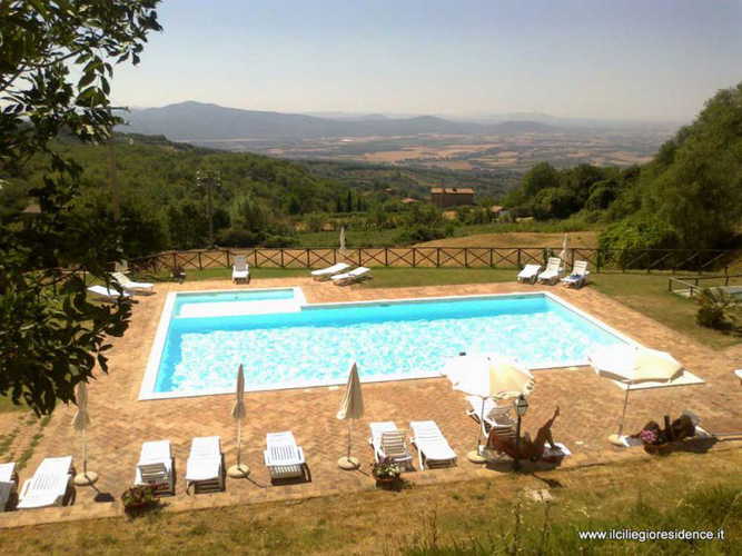 Large family friendly pool with umbrellas and chaise lounges