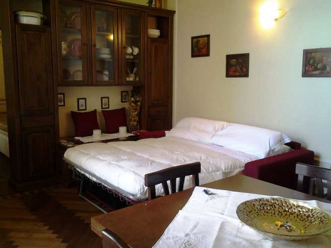 The living room with the coloured sofa bed