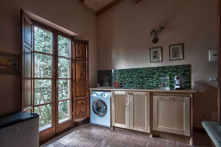 I colori tenui e l'arredo semplice accentuano lo stile tipico toscano