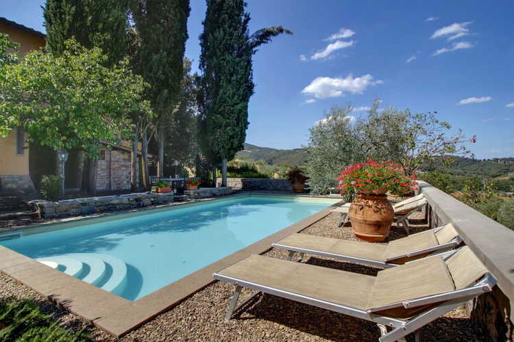 Deluxe swiming pool with loungre chairs at Villa Stolli