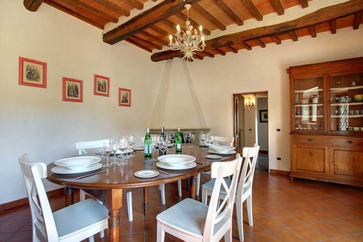 Enjoy meals together in the dining room with fireplace at Villa Stolli