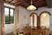 The furnishings are in Tuscan rural style, with exposed wooden beamed ceilings, a classic in Tuscan country homes