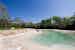 The stone outdoor pool surrounded by the green park